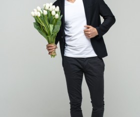Handsome young male holding flowers Stock Photo