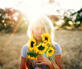 Holding sunflower flowers back light girl Stock Photo