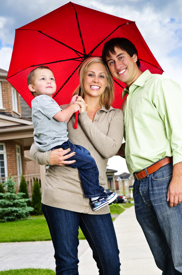 Holding the child with an umbrella mother and father Stock Photo
