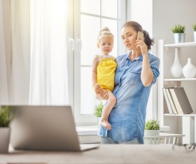 Holding the childs mother answered the phone Stock Photo