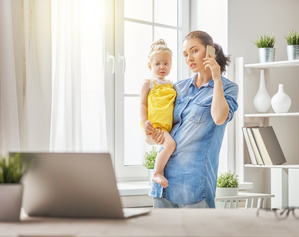 Holding the childs mother answered the phone Stock Photo
