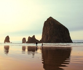 Human walking on calm rocky beach Stock Photo
