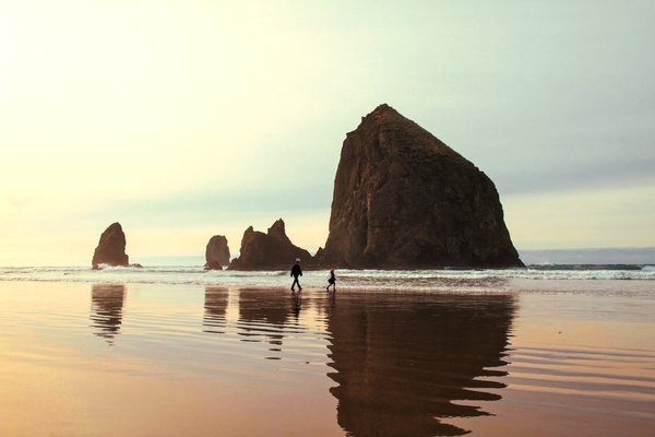 Human walking on calm rocky beach Stock Photo