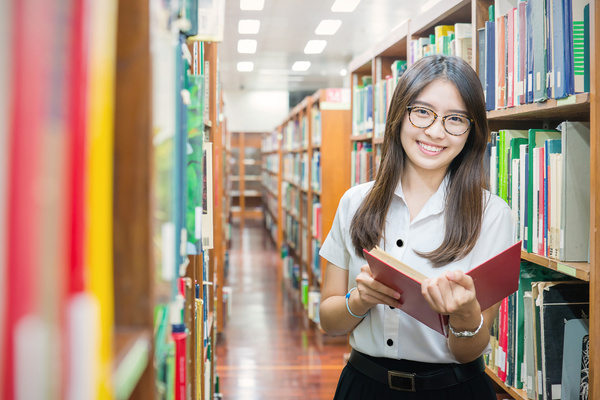 Library reading female student Stock Photo
