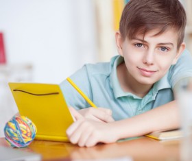 Little boy writing homework Stock Photo