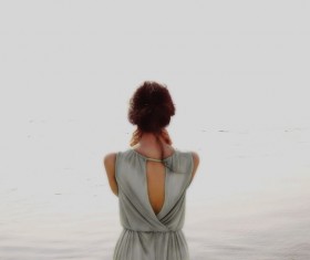 Look at the sea woman back shadow Stock Photo