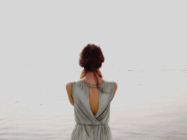 Look at the sea woman back shadow Stock Photo