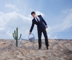 Man watering the cactus Stock Photo