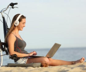 Online chat on the beach happy woman Stock Photo