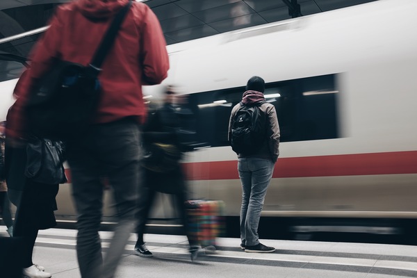 Pedestrian waiting by fast train Stock Photo