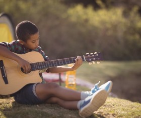 Play the guitar little boy Stock Photo