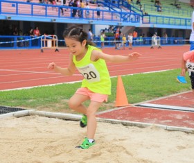 Pupils long jump Stock Photo