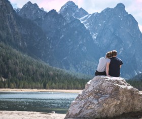 Romantic couple relaxing on mountain river scene Stock Photo