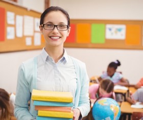 Smiling students holding books Stock Photo
