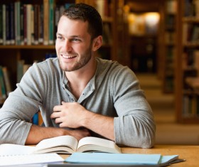 Smiling boys studying in the library Stock Photo