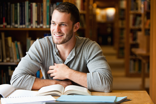 Smiling boys studying in the library Stock Photo