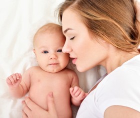 Smiling mother holding the baby Stock Photo 04
