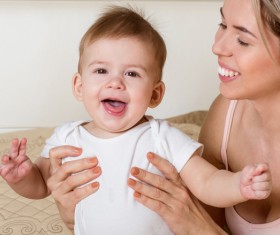 Smiling mother holding the baby Stock Photo 11