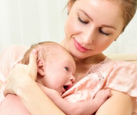 Smiling mother holding the baby Stock Photo 12