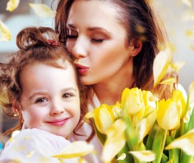 Smiling mother kissing daughter Stock Photo