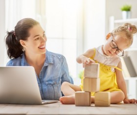 Smiling mother watching the child play on their own Stock Photo