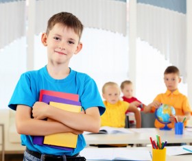 Smiling students holding books Stock Photo