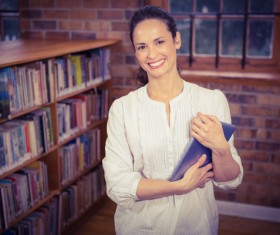 Smiling woman in the library Stock Photo