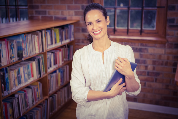 Smiling woman in the library Stock Photo