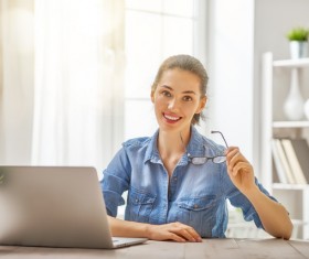 Smiling woman with tablet on the desktop Stock Photo