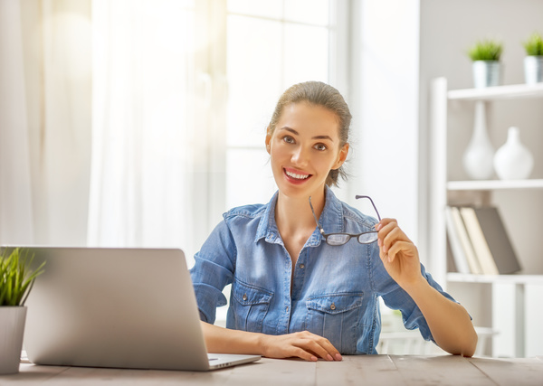 Smiling woman with tablet on the desktop Stock Photo