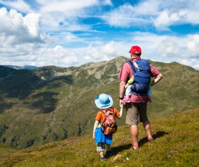 Standing on the mountain to enjoy the scenery of the father and son Stock Photo