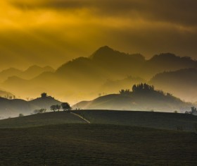 Sun beams on beautiful highland landscape at dusk Stock Photo