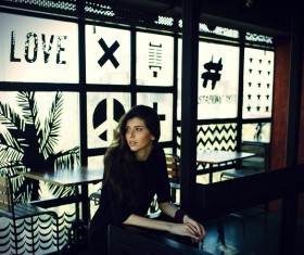 The beautiful girl sitting in the restaurant Stock Photo