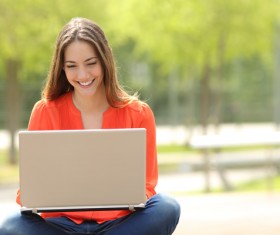 Use the computer to chat online happy girl Stock Photo