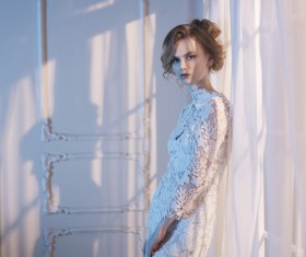 Woman in lace dress at the window Stock Photo 01