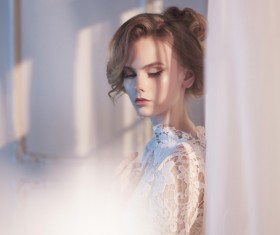 Woman in lace dress at the window Stock Photo 02