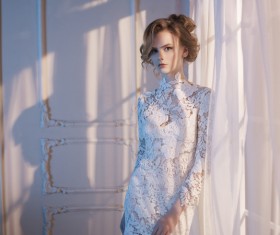 Woman in lace dress at the window Stock Photo 03