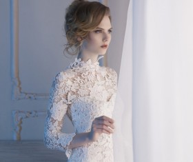 Woman in lace dress at the window Stock Photo 05