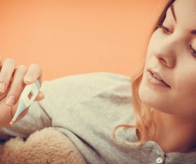 Woman measuring body temperature Stock Photo