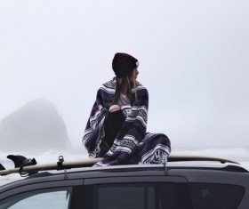 Woman sitting on car dome with traditional cloth Stock Photo
