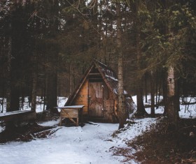 Wooden cottage in forest in wintertime Stock Photo