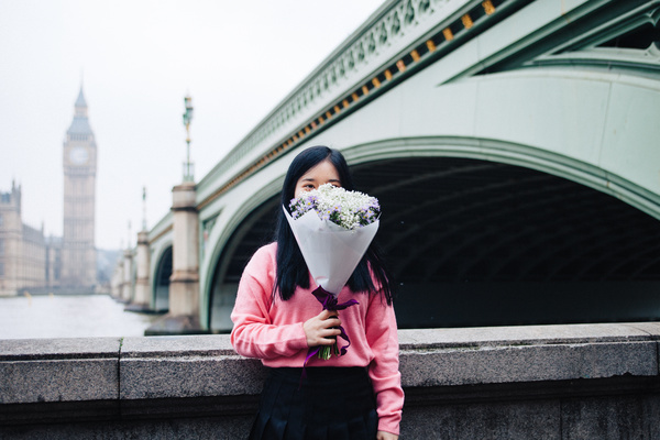 Young girl posing with flowers in classical city Stock Photo