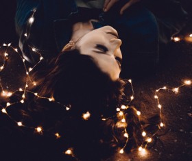 Young woman posing with bright decorative lights Stock Photo