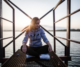 Young woman relaxing on lake side Stock Photo