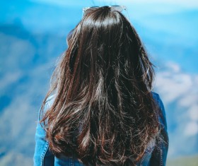 Young woman watching mountain scene Stock Photo