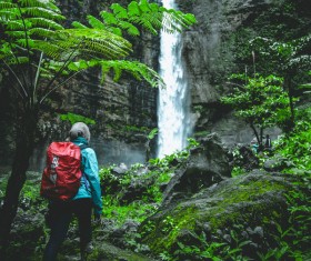 mountain climber who sees the mountain waterfall Stock Photo