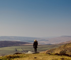 person standing in front of wide land Stock Photo