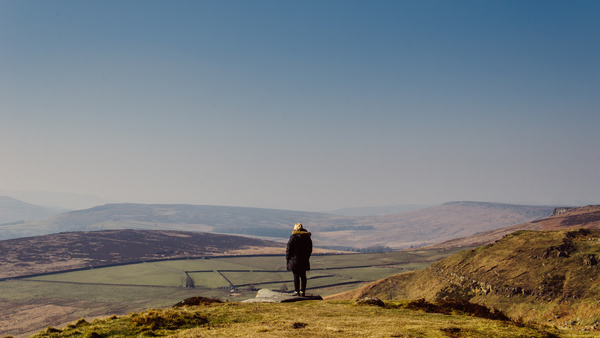 person standing in front of wide land Stock Photo