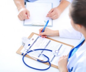 woman doctor writes a case Stock Photo