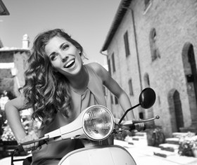 Black and white photo of girl riding a motorbike Stock Photo
